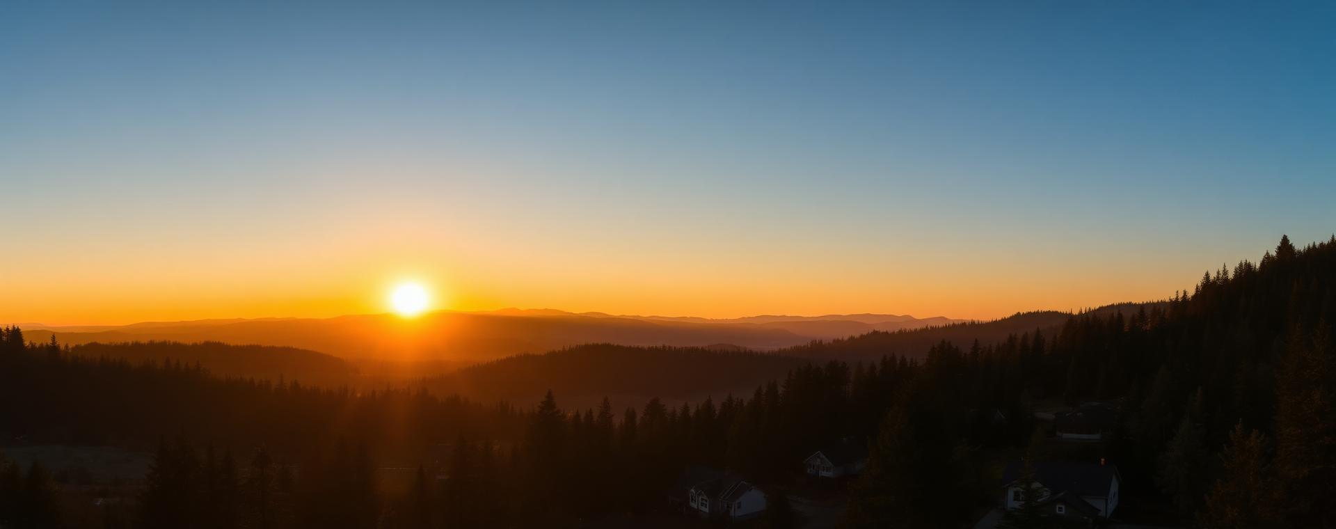 Sunrise over forested Oregon ridges above a quiet residential valley